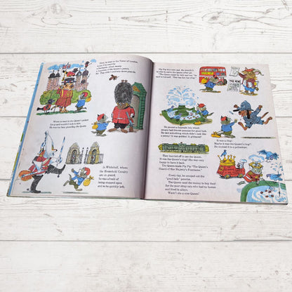 Open book with illustrated pages on a wooden surface