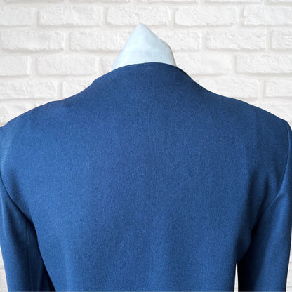 Blue jacket  on a mannequin against a white brick wall background