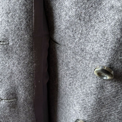 Close-up of a textured gray fabric with a button 