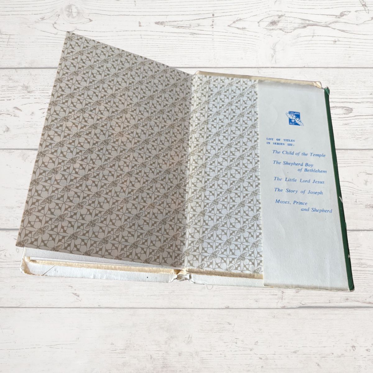 Open book with patterned cover on a wooden surface