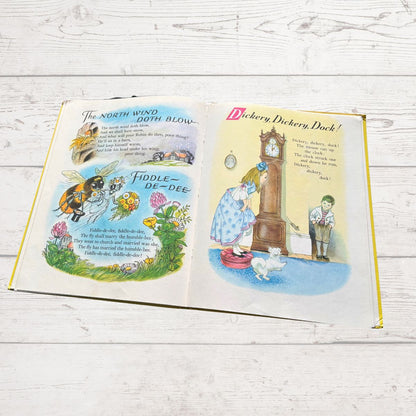 Open book with illustrated pages on a wooden surface