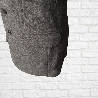Brown textured coat on a white brick wall background