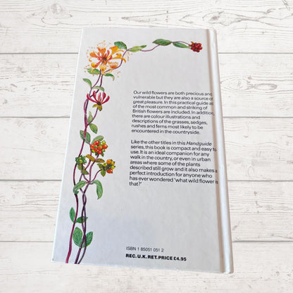 Book with floral illustrations on a white wooden surface