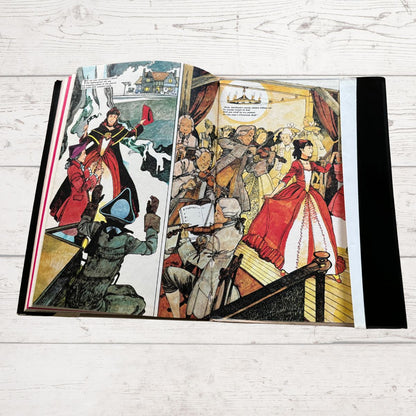 Illustrated book open to a page with colorful characters on a wooden surface