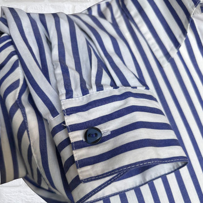 Close-up of a blue and white striped shirt with a button.