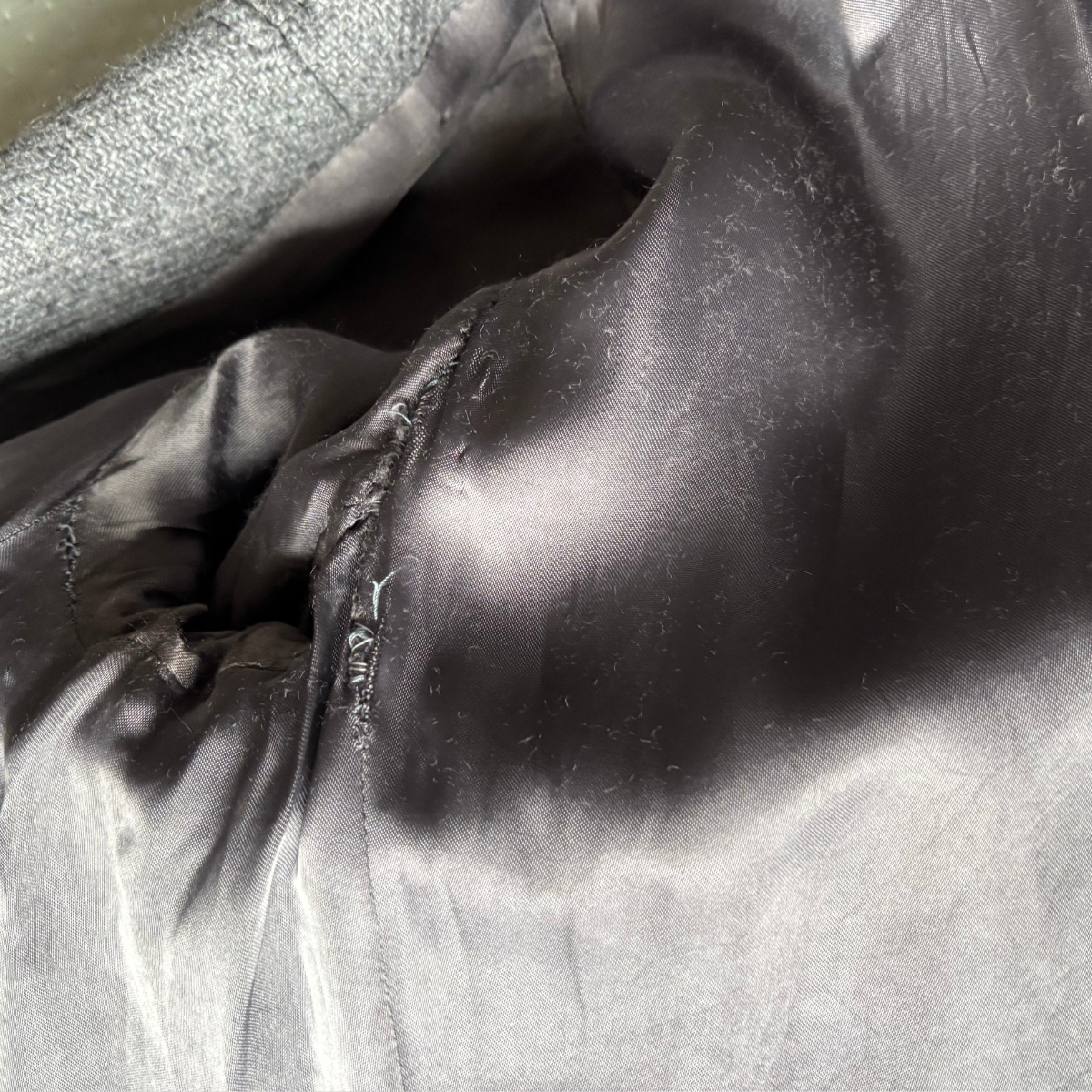 Close-up of the coat lining surface with folds and shadows.
