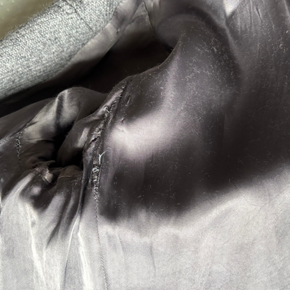 Close-up of the coat lining surface with folds and shadows.