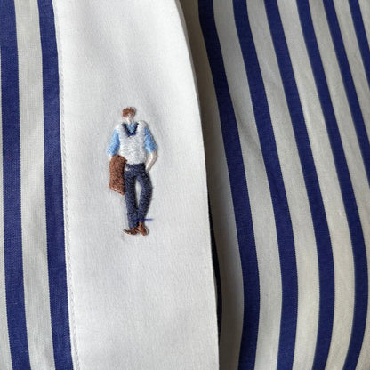 Embroidered design of a person on a blue and white striped fabric