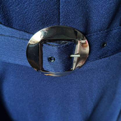 Close-up of a blue dress belt with a shiny silver buckle