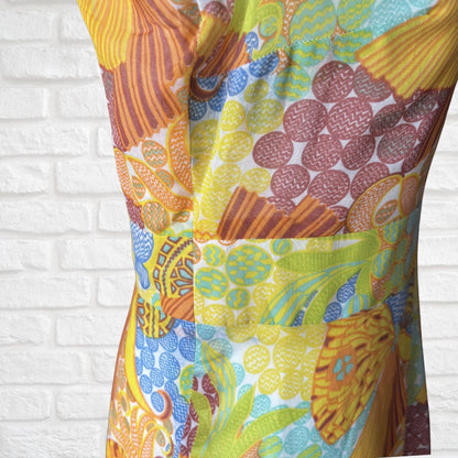 Colourful dress with  patterned design on a white brick wall background