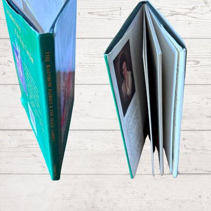 Open book with a teal cover on a wooden surface