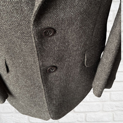 Close-up of a brown textured coat with buttons on a white background