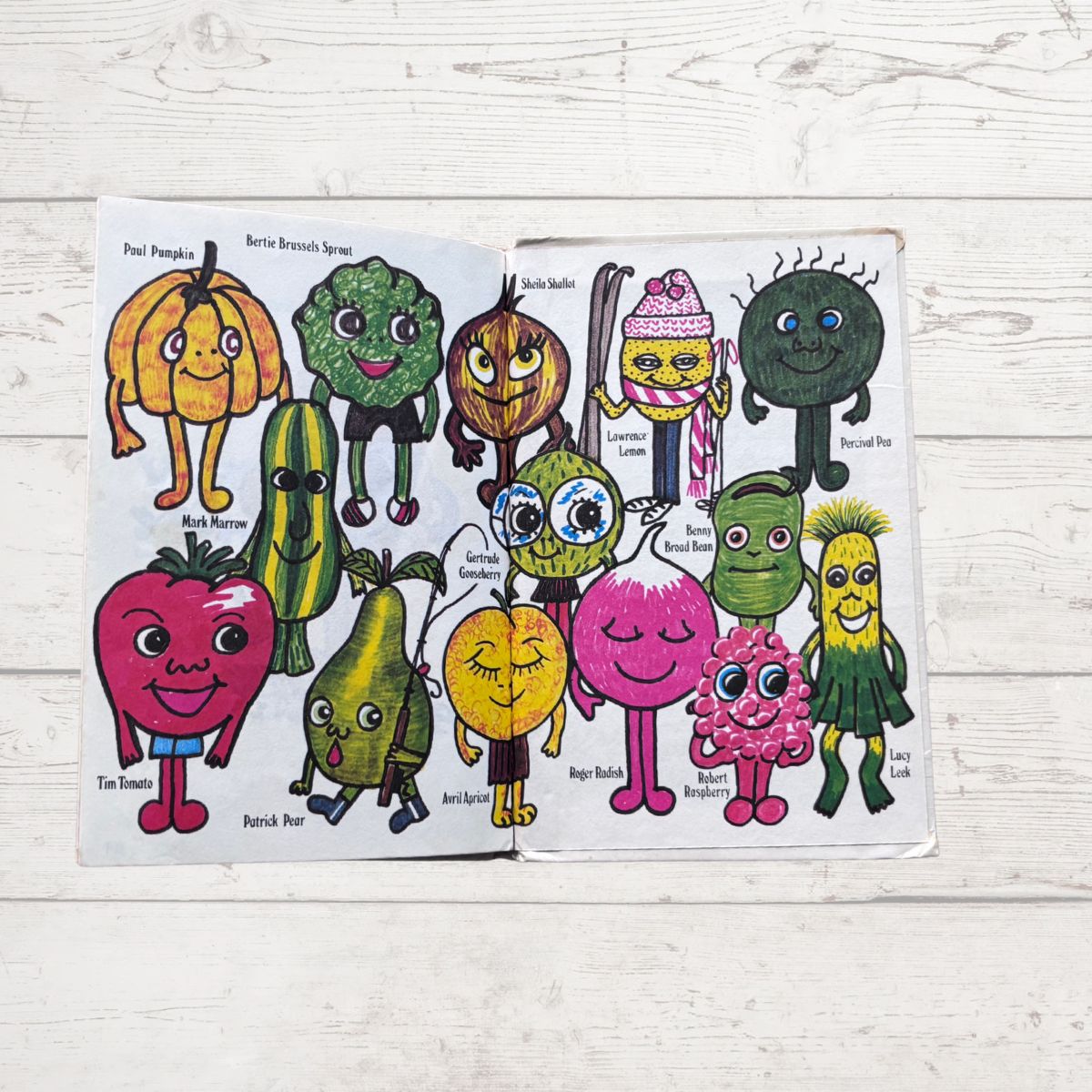 Colorful fruit and vegetable characters on a wooden surface