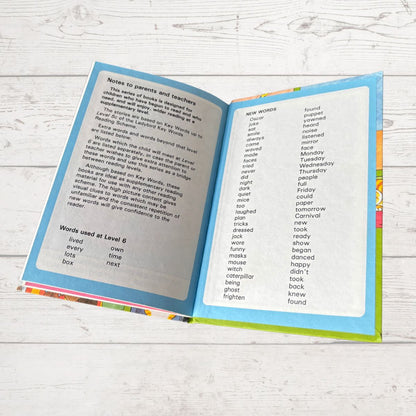 Open book on a wooden surface with text and colorful margins