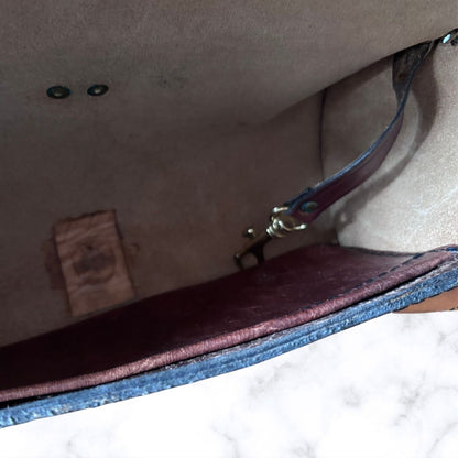Close-up of the interior of a  bag showing a beige suede-like interior