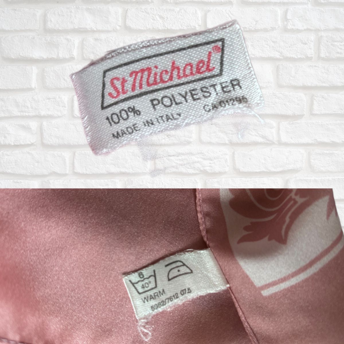St. Michael label on a pink fabric with a white brick background