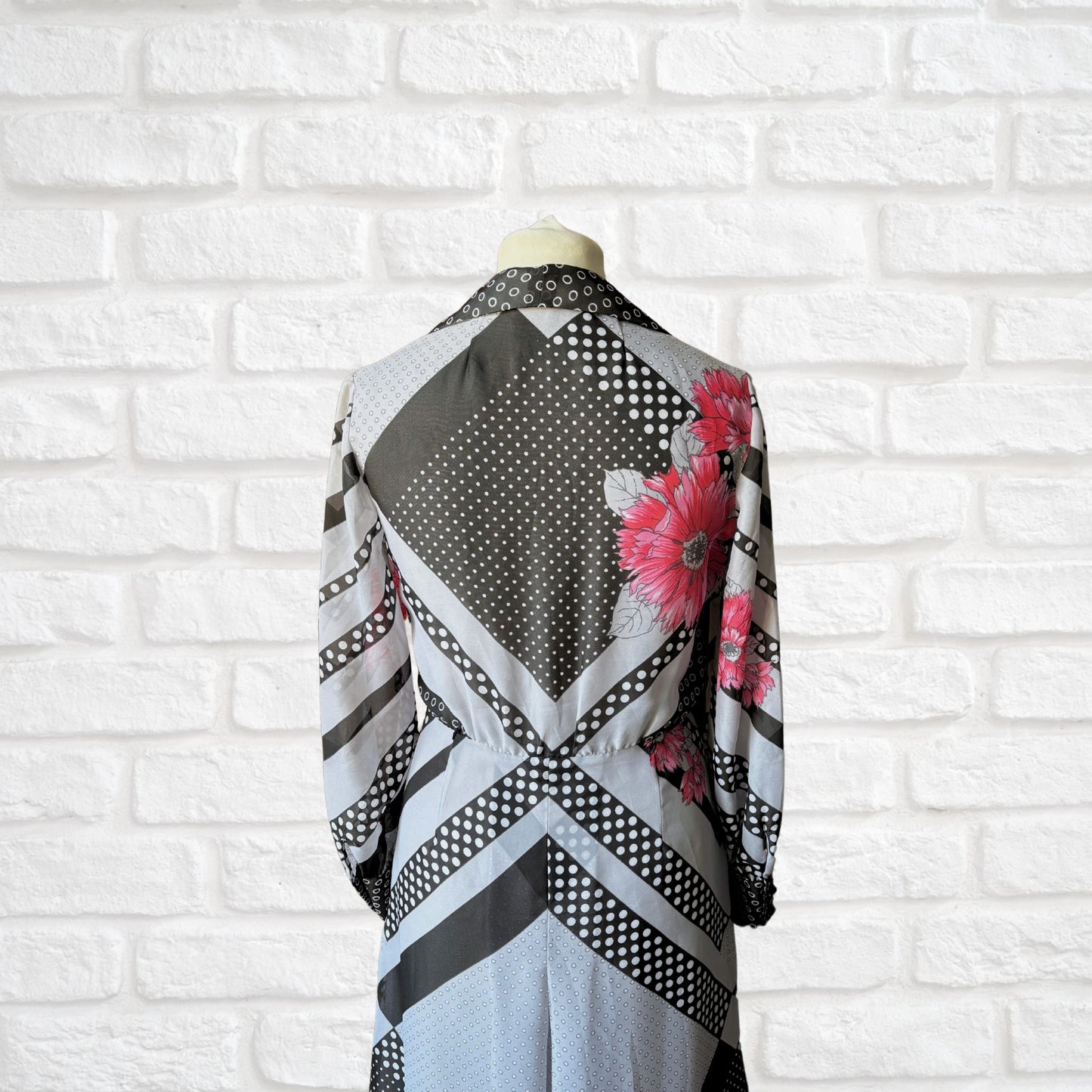 70s vintage long-sleeved maxi dress with grey and black stripes, polka dots, and floral design - back top view 