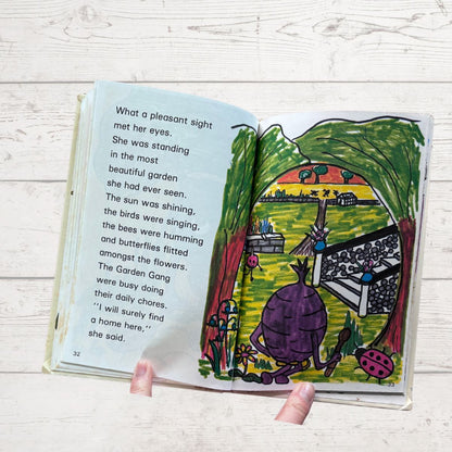Open book with colorful illustration and text on a wooden surface