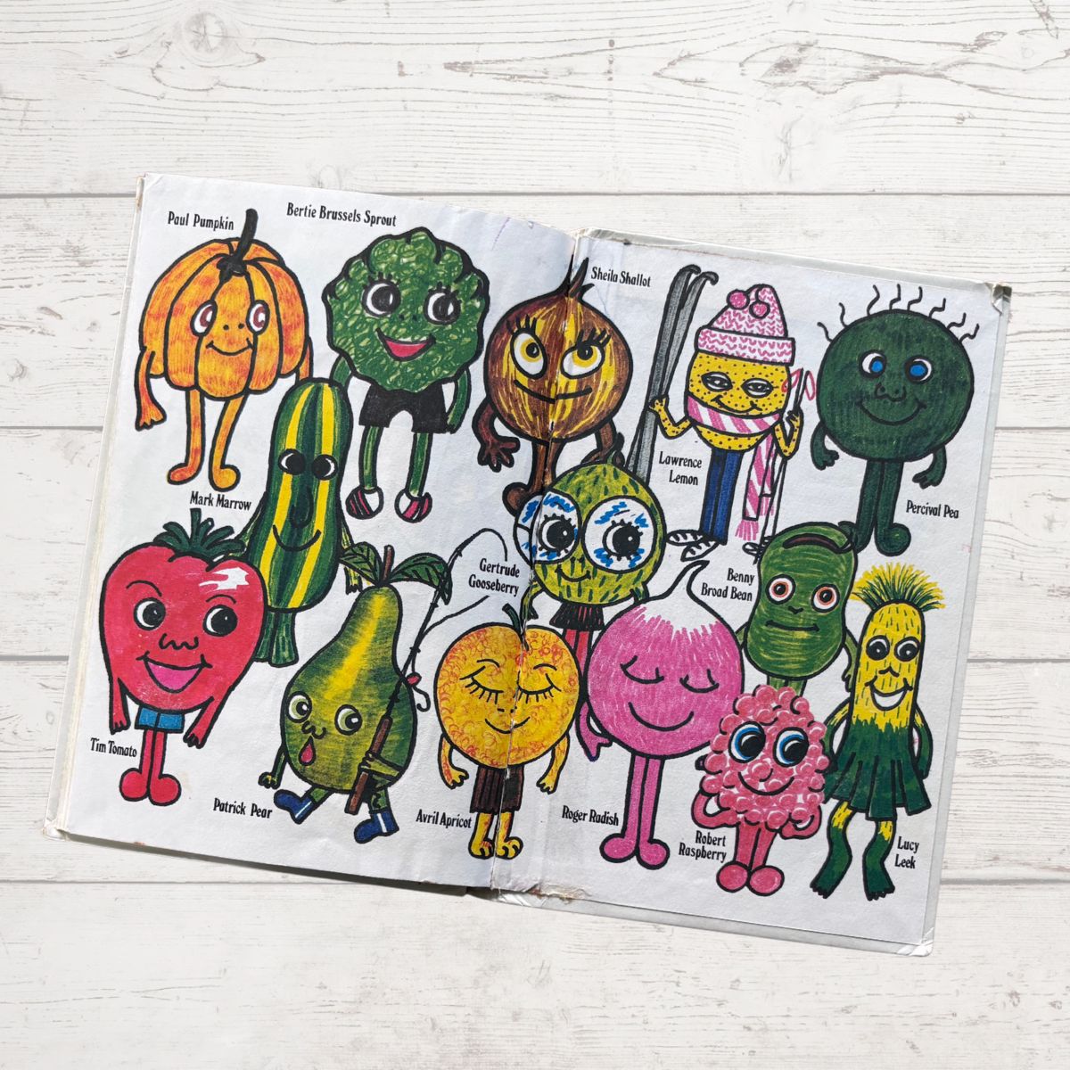 A  book with cartoon vegetables on a wooden surface