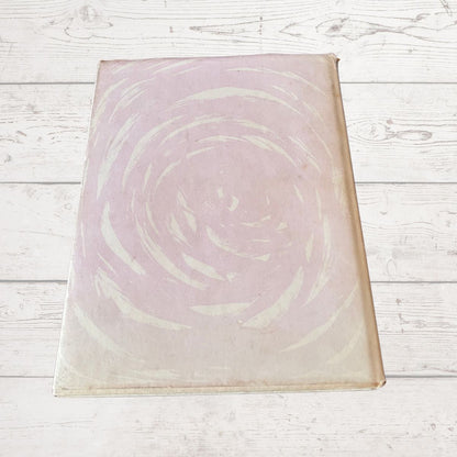 Book cover  with a circular design on a light wooden surface