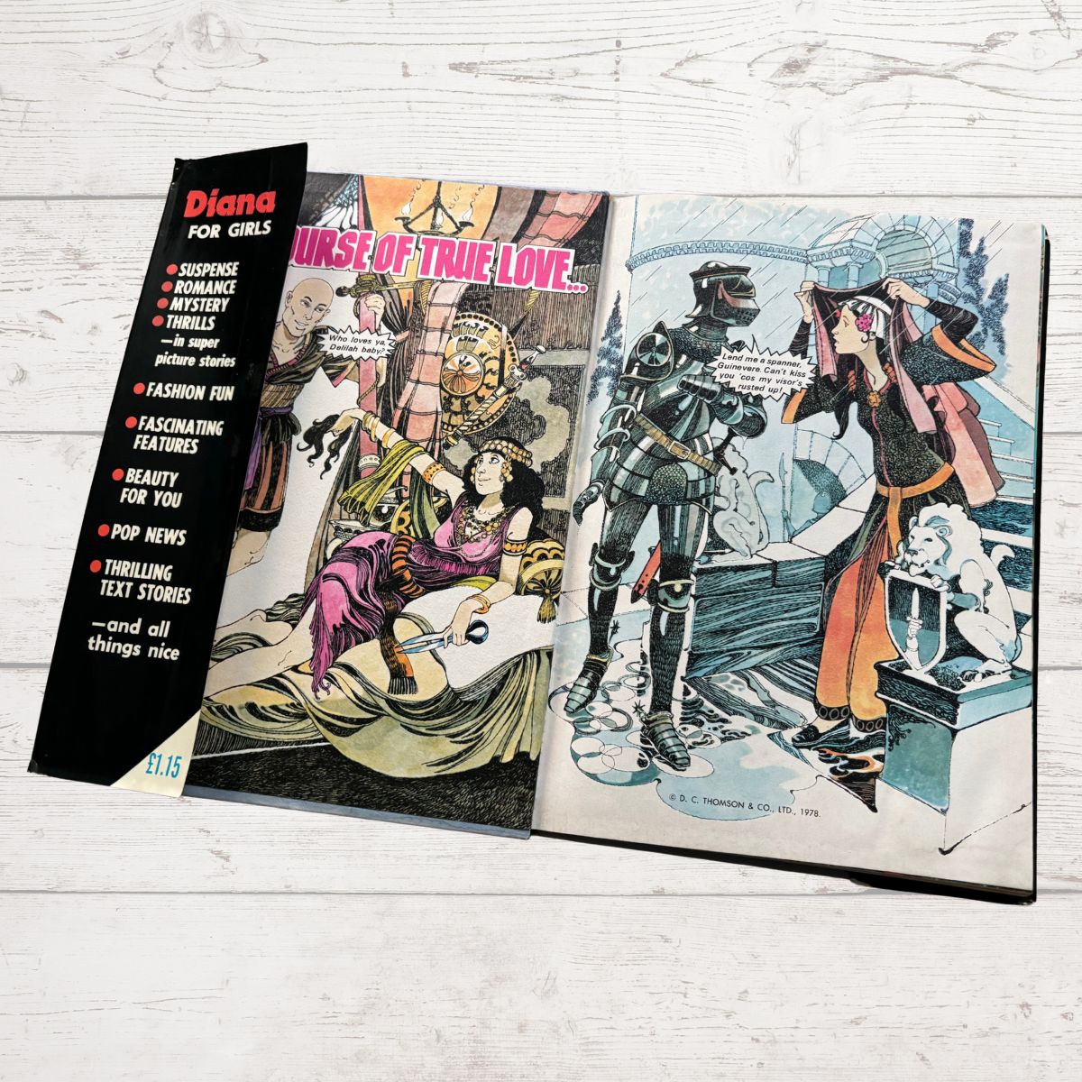 Vintage comic book open to a page with illustrations on a light wooden surface
