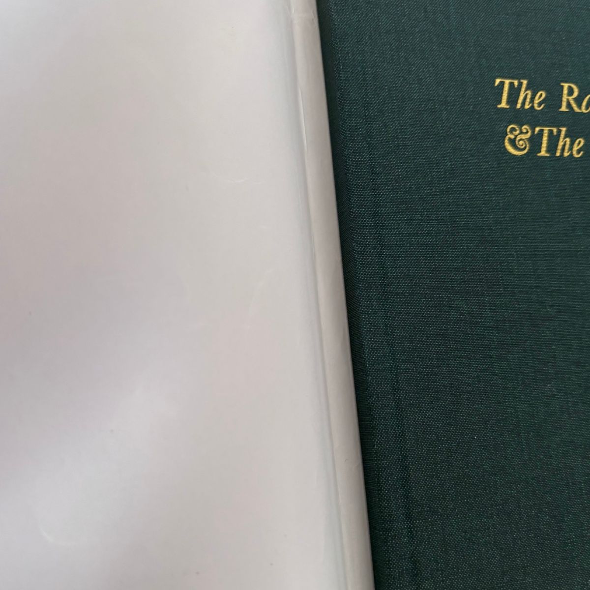 Green book with gold text on a white background