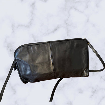 Black leather bag on a marble surface