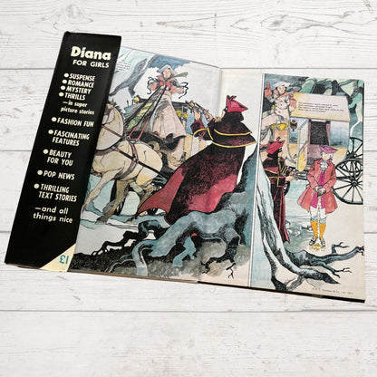 Open book with illustrated pages and a black cover titled 'Diana for Girls' on a wooden surface.