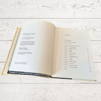 Open book on a wooden surface with text visible