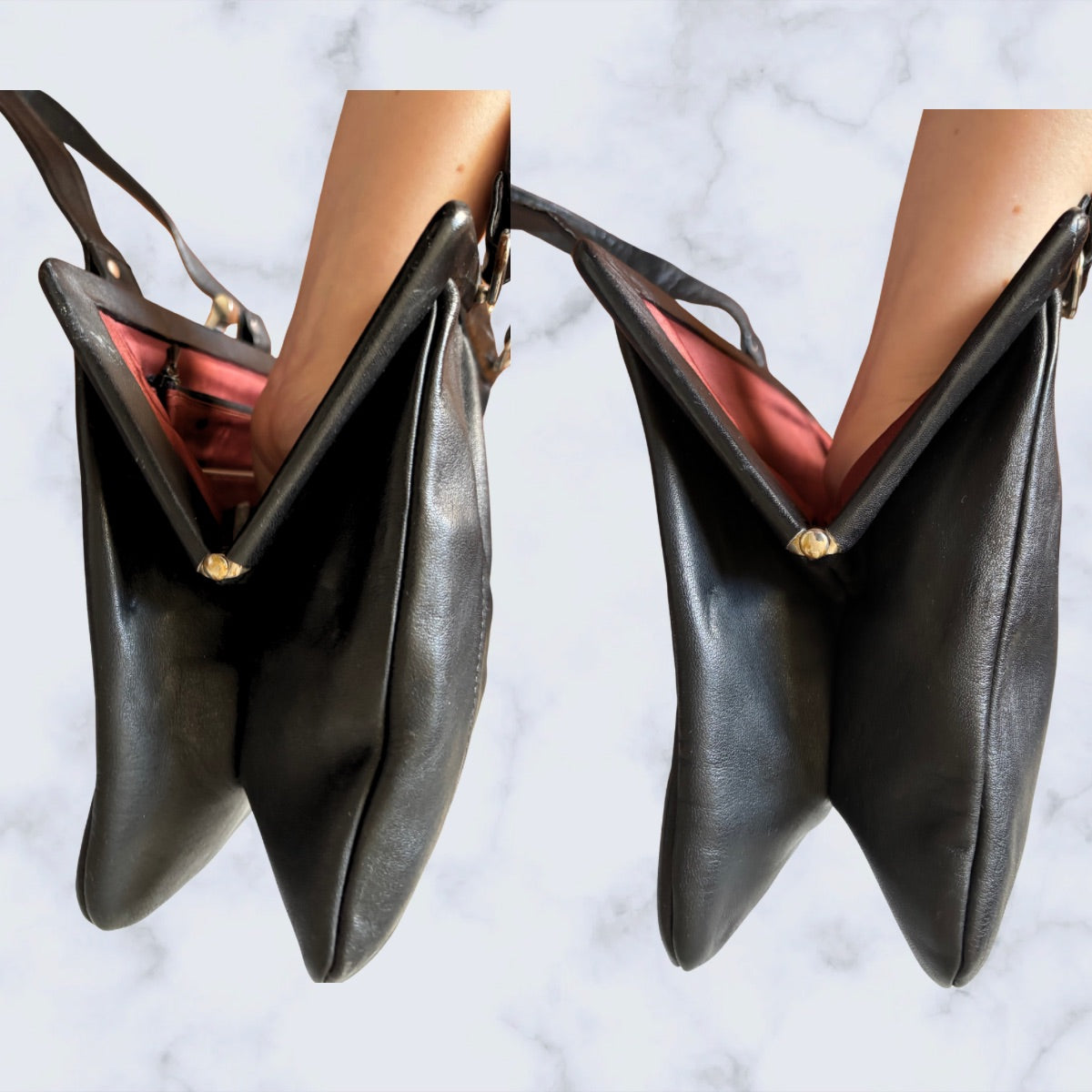 Black leather handbag held by a person against a marble background