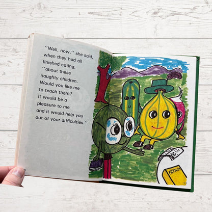 Open book with colorful illustrations of characters on a wooden surface