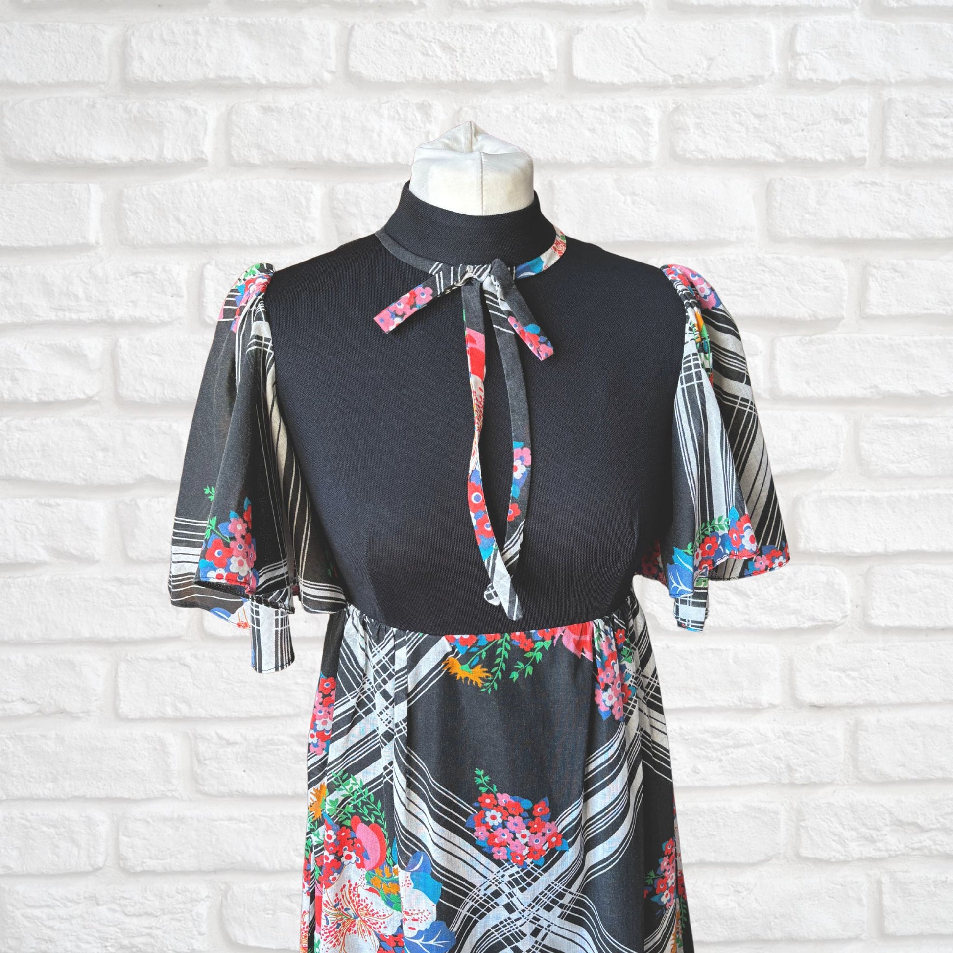  70s vintage maxi dress by Richard Shops with black high neck bodice and  floral angel sleeves  - top front view 
