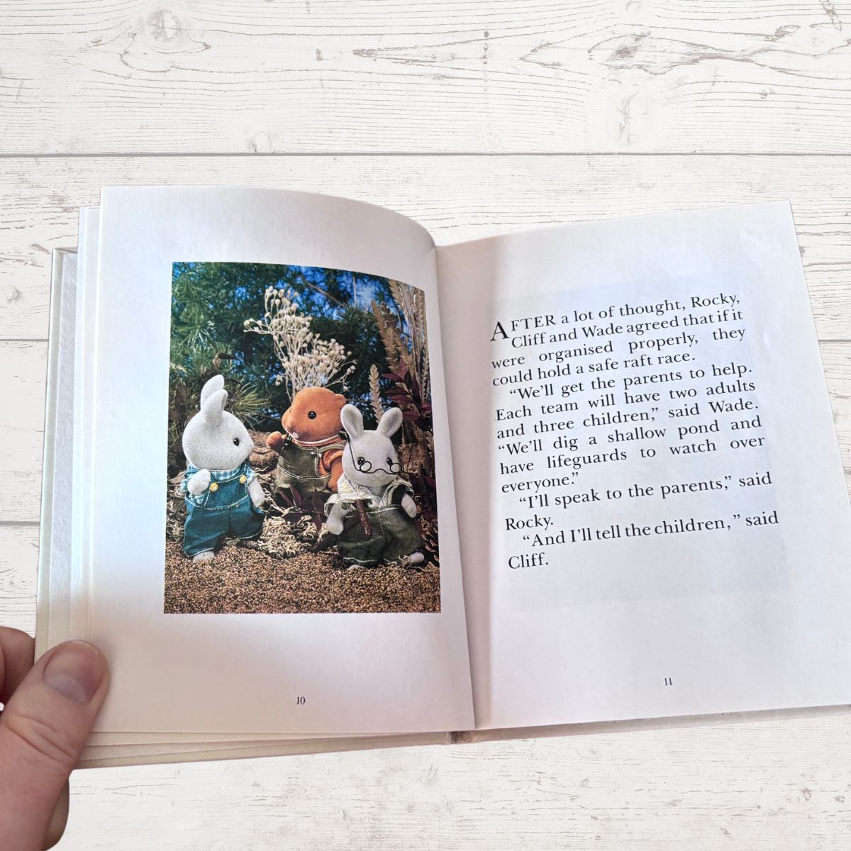 Open book with illustrations of animated characters on a wooden surface