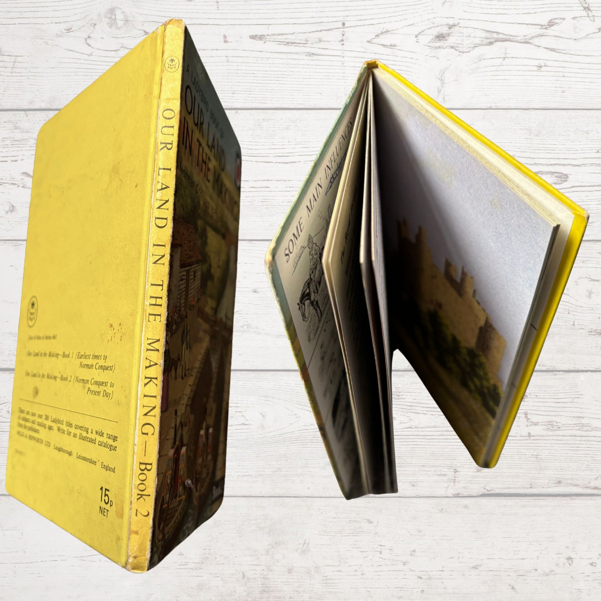 Open book with yellow cover on a wooden surface