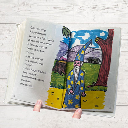 Illustrated book page with a wizard and fairy on a wooden surface