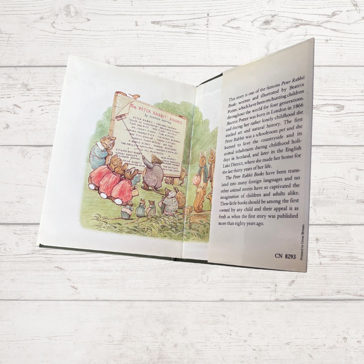 Open book with illustrations and text on a wooden surface