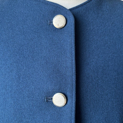 Close-up of a blue garment with silver  buttons