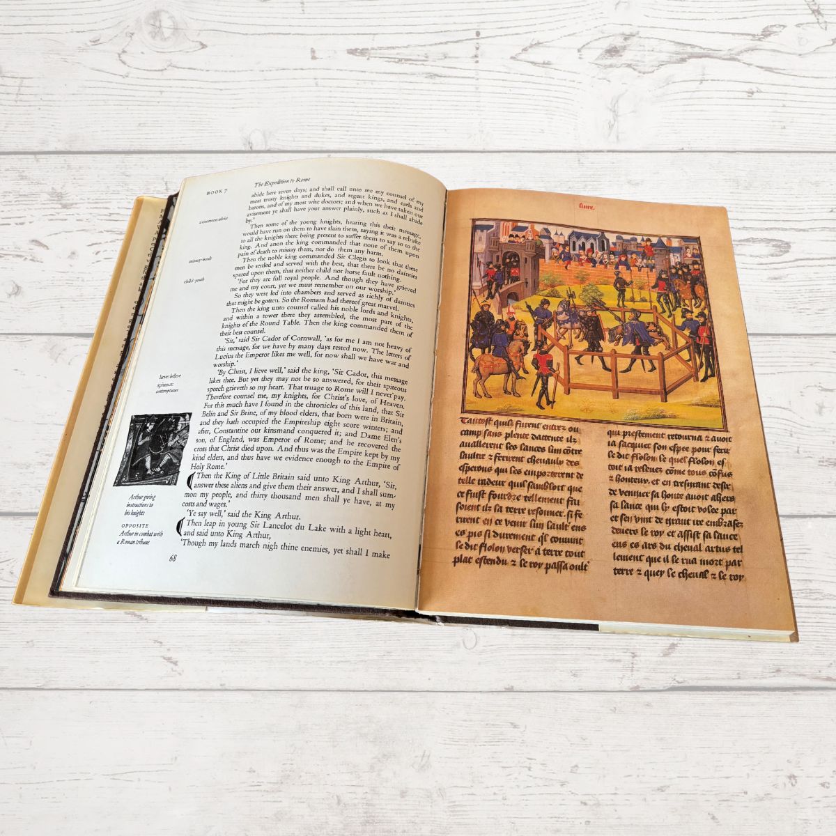 Open book with text and illustrations on a wooden surface