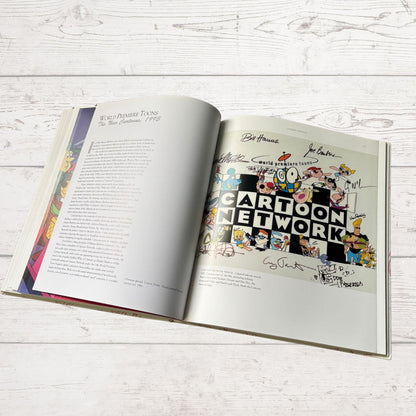 Open book with a cartoon-themed page on a light wooden surface