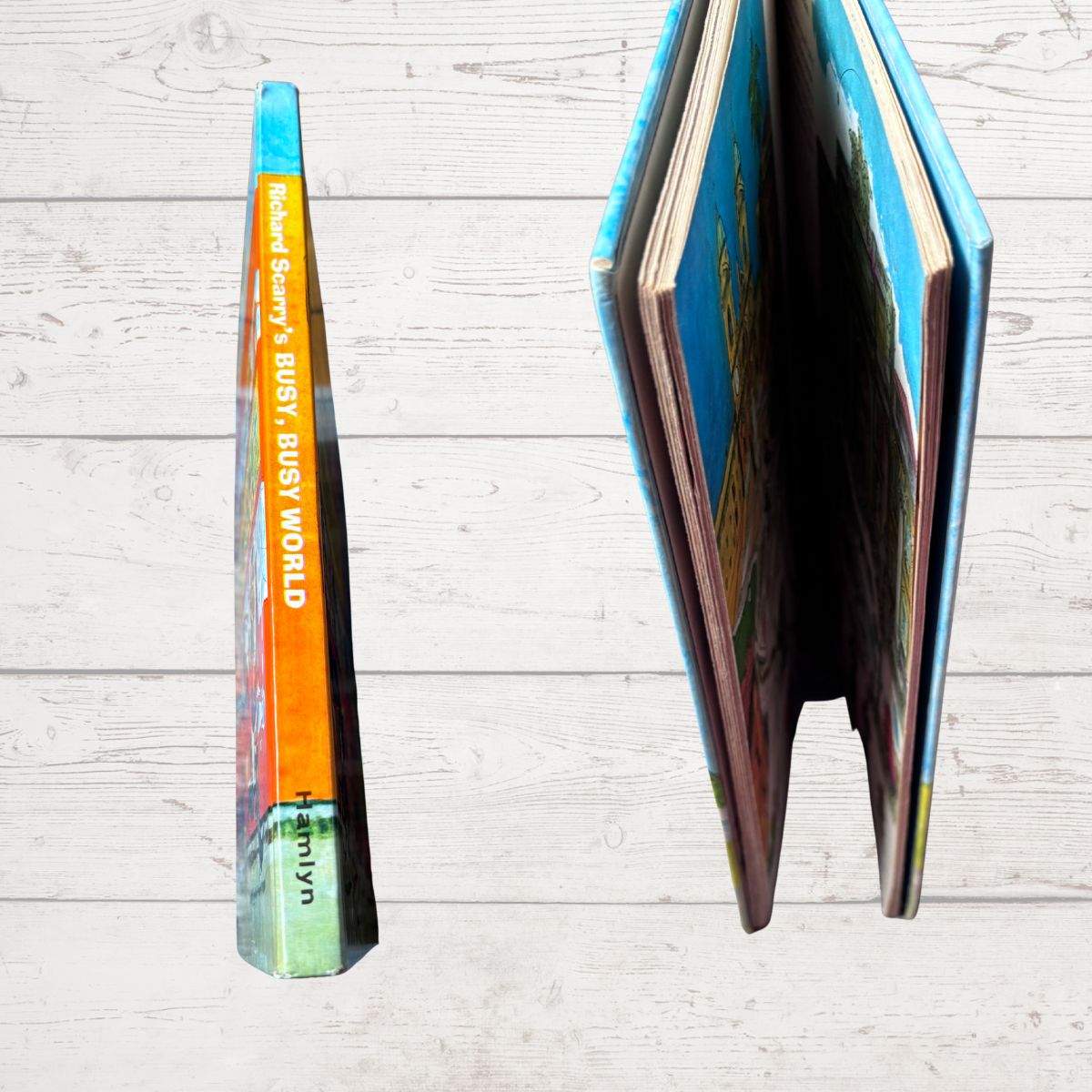 Open book with colorful pages on a light wooden surface