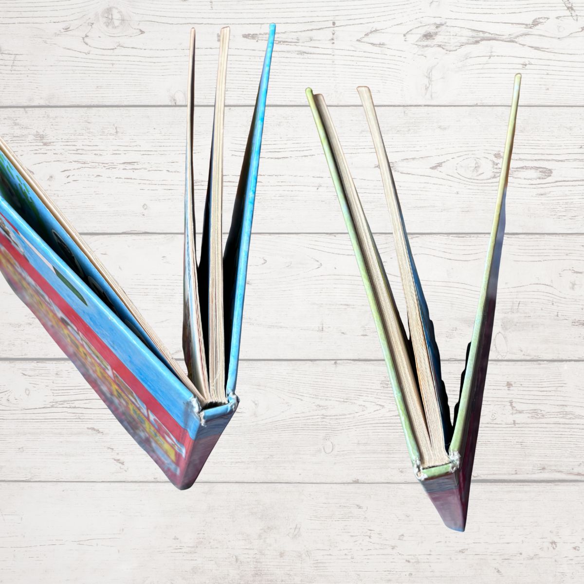 Open books on a light wooden surface