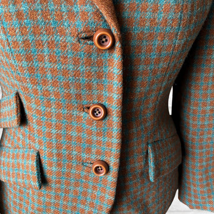 Close-up of a checkered suit jacket with brown buttons on a white background