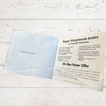 Open book with promotional text for Roger Hargreaves books on a wooden surface