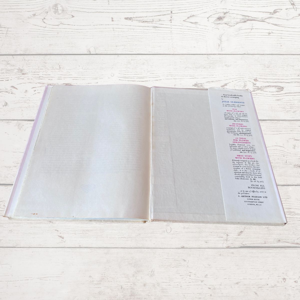 Open book with a page of text on a light wooden surface