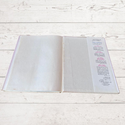 Open book with a page of text on a light wooden surface