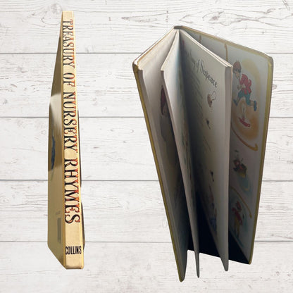 Open book titled 'Treasury of Nursery Rhymes' by Collins on a wooden surface