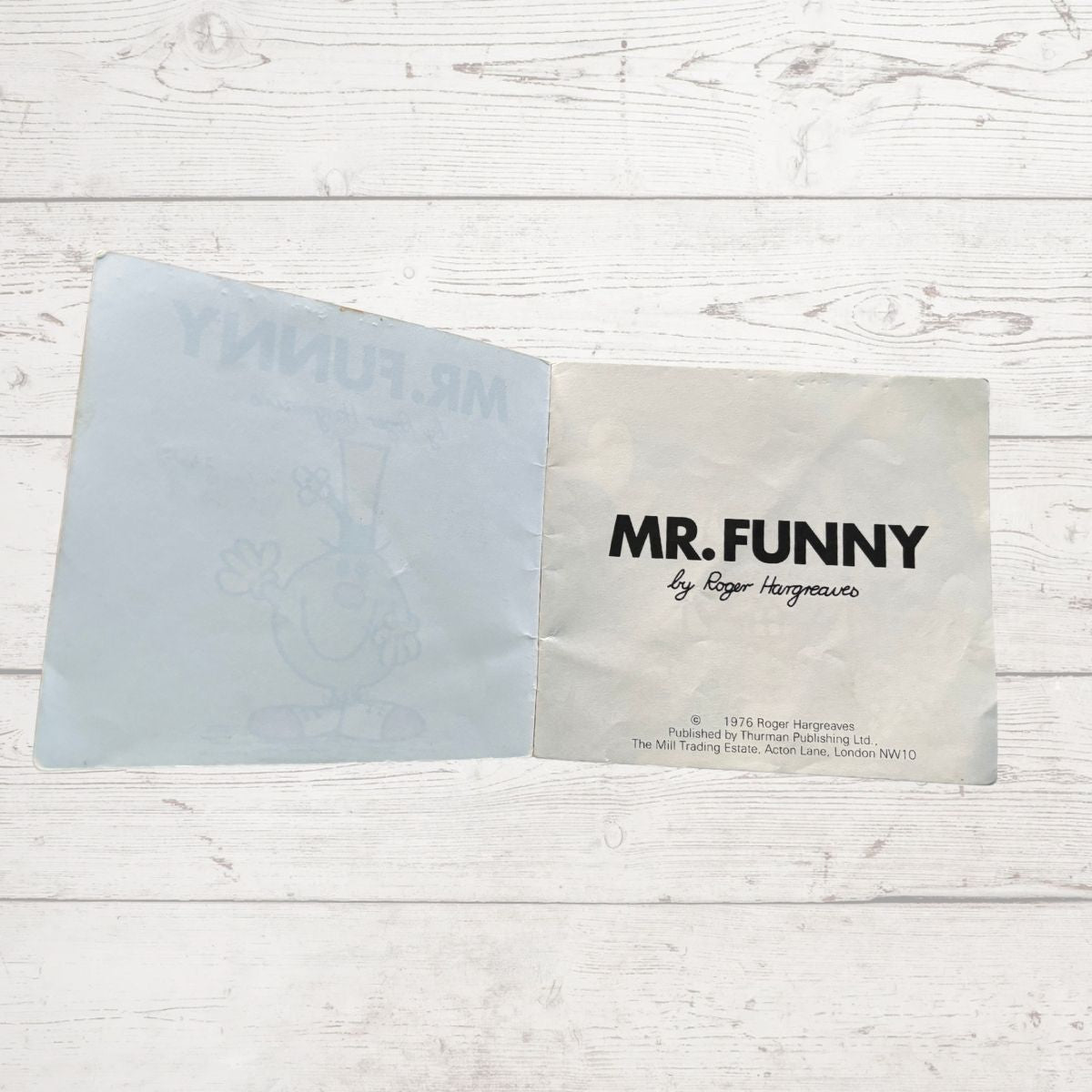 Open book with 'MR. FUNNY' by Roger Hargreaves on a wooden surface