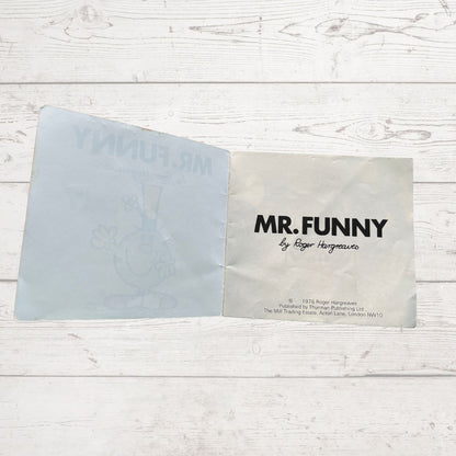 Open book with 'MR. FUNNY' by Roger Hargreaves on a wooden surface