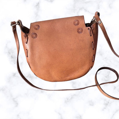 Tooled leather shoulder bag on a white background - back view 