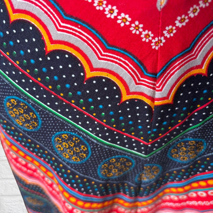 Close-up of a colourful skirt fabric with intricate patterns and vibrant colours.